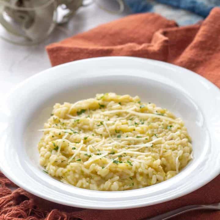 zucchini risotto in a white bowl