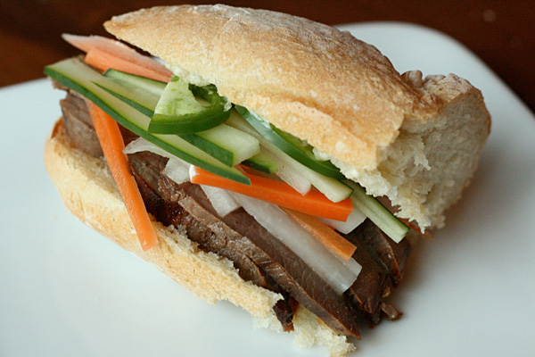 Banh Mi - Thinly sliced sirloin goes a long way when sandwiched with pickled carrots in daikon in a banh mi.