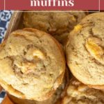 Close-up of several peach muffins in a wooden box, with a banner at the top reading "peach muffins" and showcasing their golden, fruity texture.
