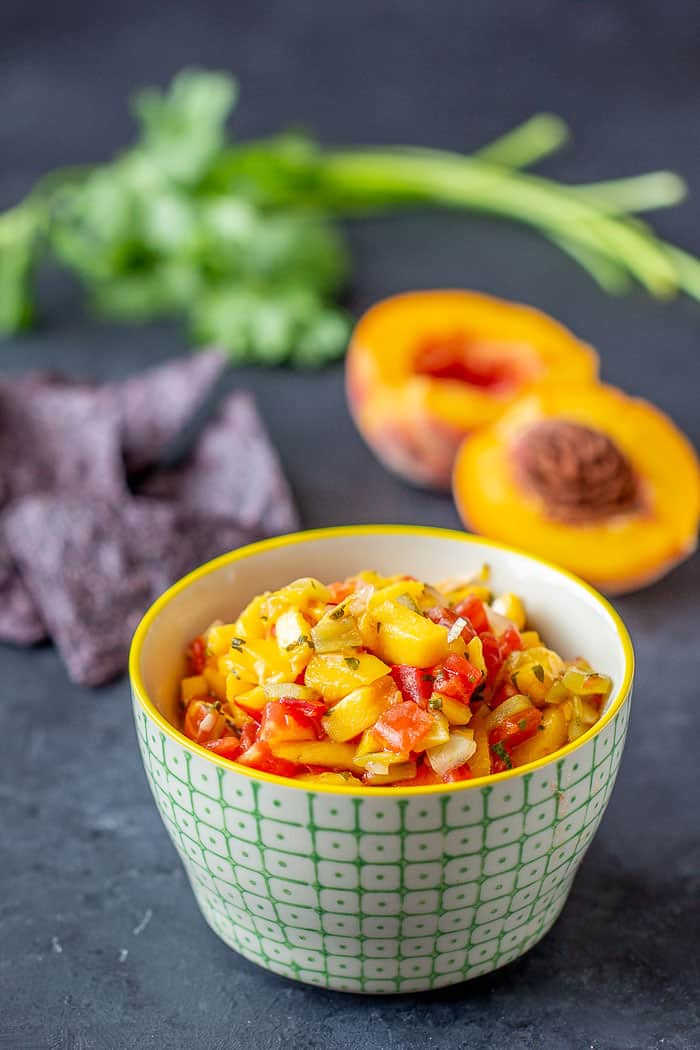 Roasted hatch peach salsa gives you spicy-sweet flavor that goes will with chicken, fish, pork, or just chips. Preserve it so you have the taste of summer all year long.