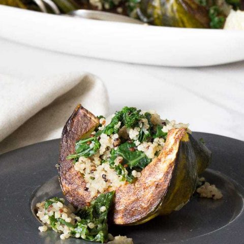 Kale and quinoa stuffed squash is an excellent side dish for Thanksgiving, or a simple meatless main.