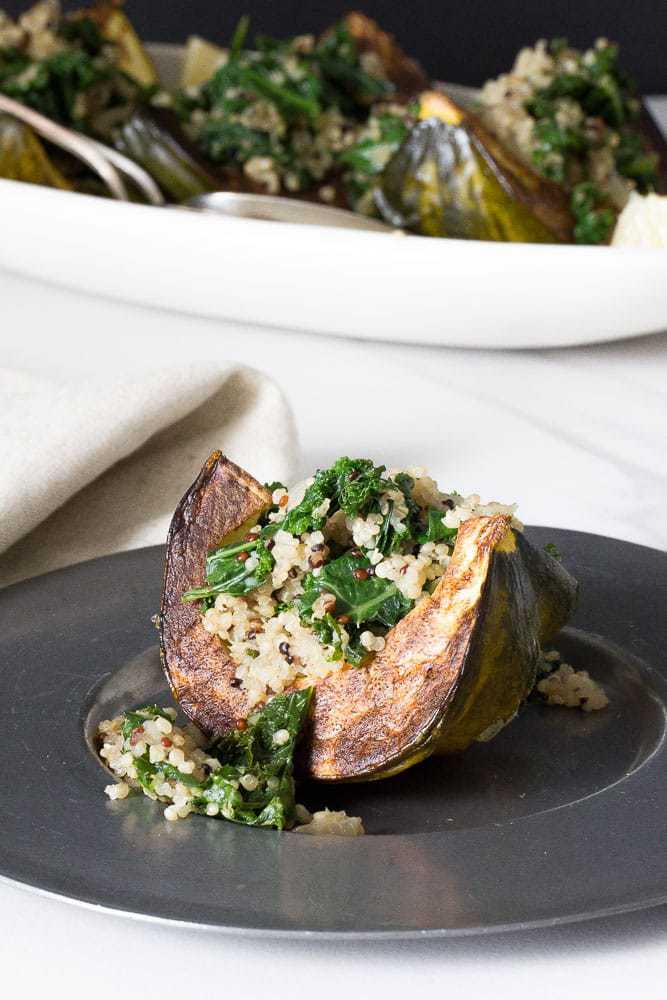 Kale and quinoa stuffed squash is an excellent side dish for Thanksgiving, or a simple meatless main.