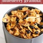 A gray bowl filled with homemade lemon blueberry granola sits on a white surface. Text above the bowl reads, "homemade blueberry granola.