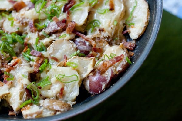 Skillet potatoes topped with cheese, bacon, and more cheese. You deserve these today.