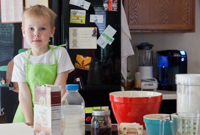Boy in kitchen with baking ingredients