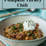 Pumpkin turkey chili simmering in a bowl on a table.