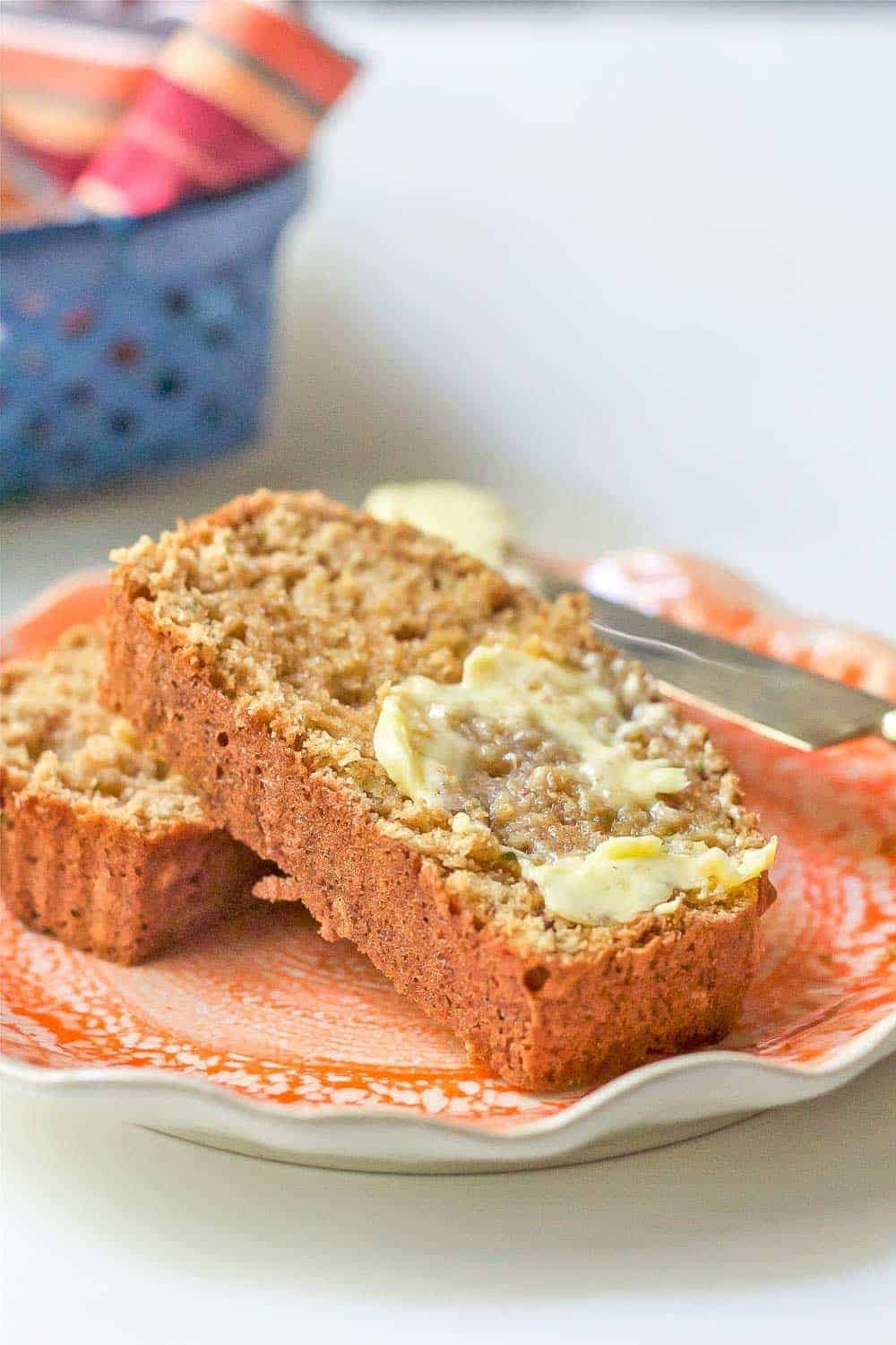 slices of zucchini bread on plate with butter