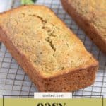 Two loaves of easy zucchini bread cooling on a wire rack, with text overlay reading "easy zucchini bread.
