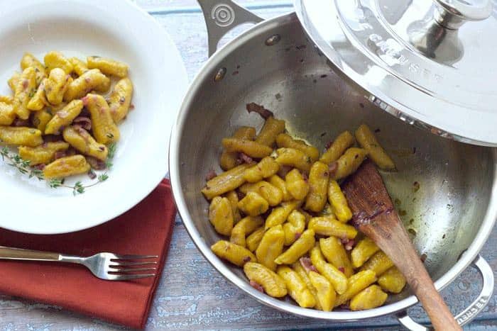 Pumpkin Gnocchi is tossed in a decadent butter-herb sauce.