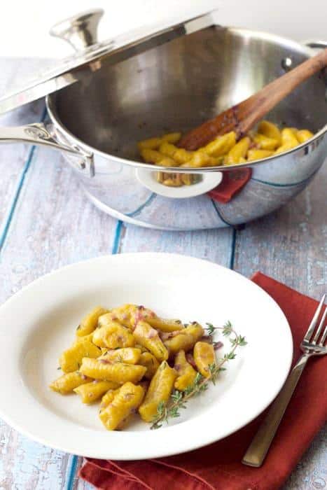 Pumpkin gnocchi is made even more decadent with a sauce of butter, shallots, bacon, and fresh herbs.