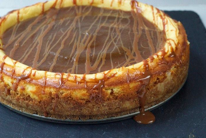 Goat cheese cheesecake is smothered in bourbon apple butter and drizzled with bourbon cajeta for a luscious, boozy dessert.