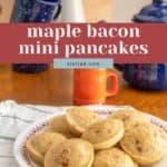 A plate of mini pancakes with maple bacon sits on a wooden table, surrounded by mugs, a blue teapot, and a vase brimming with flowers.