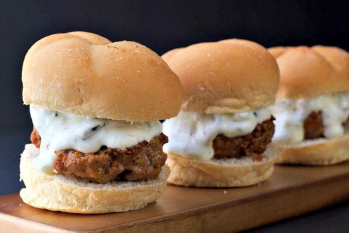 Merguez Sliders are mini lamb burgers full of flavor and topped with a cucumber-mint sauce.