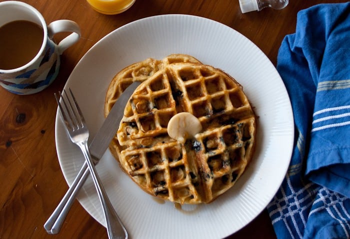 Blueberry Waffles - Start your day with blueberry waffles, bursting with sweetness and made hearty with cornmeal and whole wheat flour.