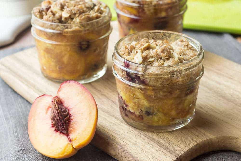 Gluten free mini peach crisps are a great dessert to have on hand for parties or for a sweet tooth attack. Plus they have blueberries!