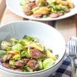 Beer-Glazed Sausage with Brussels Sprouts and Apples are the perfect dish for a cozy October night.