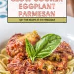 A plate of spaghetti topped with slow cooker eggplant parmesan, garnished with fresh basil. Text overlay reads "Slow Cooker Eggplant Parmesan" for an easy and flavorful dinner.