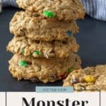 A stack of monster cookies on a black background.