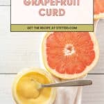 A jar of homemade Grapefruit Curd with a spoon sits beside a halved grapefruit on a white surface. Text overlay reads, "Grapefruit Curd. Get the recipe at stetted.com.