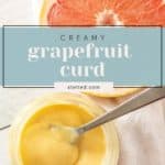 A jar of luscious Grapefruit Curd with a spoon, beside a cut grapefruit and a white cloth. Text overlay reads "Creamy grapefruit curd stetted.com".