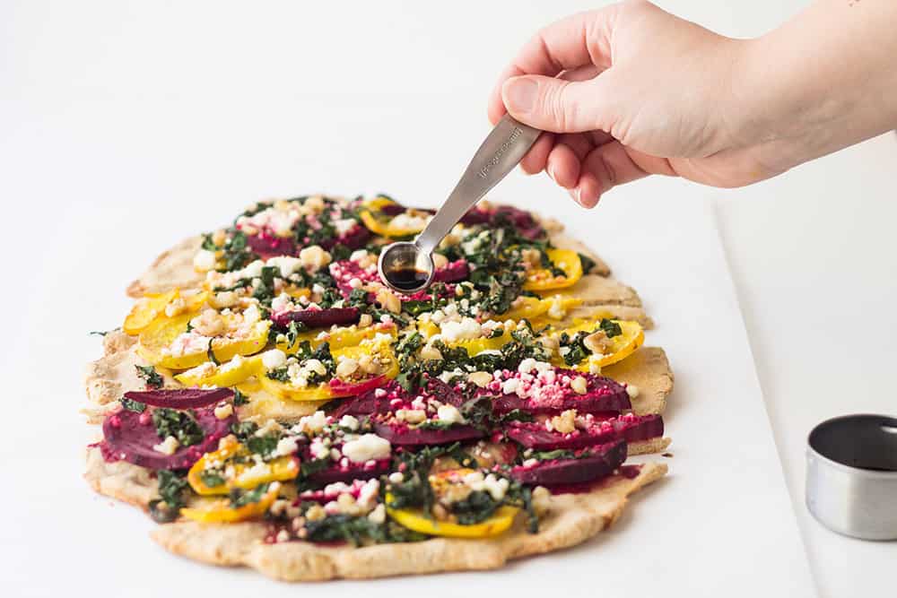 Kale beet pizza with balsamic pouring