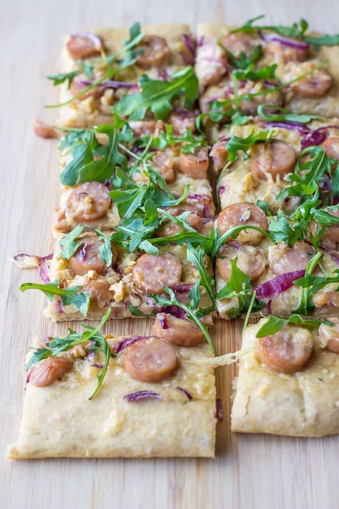 Maple-walnut chicken sausage pizza is made with whole wheat dough and adds lots of flavor from arugula and just a drizzle of maple syrup.