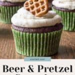 Chocolate cupcakes with a swirl of white frosting, garnished with a small pretzel on top, are presented as a recipe for "beer and pretzel cupcakes.