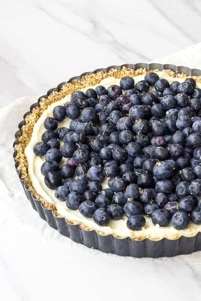 Blueberry white chocolate tart uses luscious mascarpone cheese and an almond crust for a dessert that's easy to make ahead.