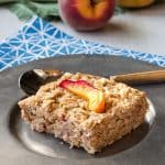 baked peach oatmeal slice on a silver plate