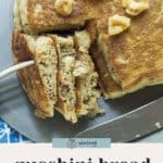 Sliced zucchini bread pancakes topped with walnuts are served on a metal tray, with a serving utensil tucked beneath the stack of zucchini bread pancakes.
