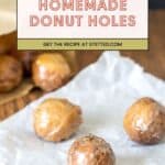Three glazed coffee donut holes rest on crumpled parchment paper, with more donut holes in a brown paper bag in the background. Text overlay says "Homemade Donut Holes.