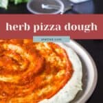 A herb pizza dough crust is topped with tomato sauce and served on a metal tray. In the background, a pizza cutter, grater, and fresh herbs create a rustic scene. Text reads: "herb pizza dough.