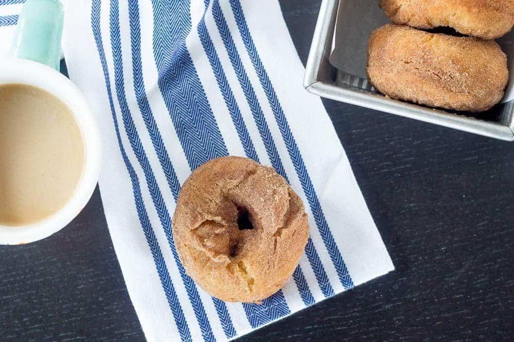 Mashed potato donuts on a table with coffee.