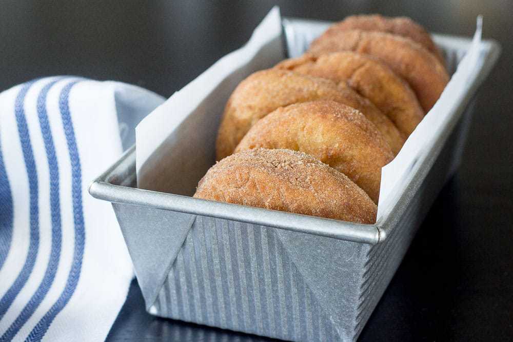 Mashed potato donuts in a baking pan.