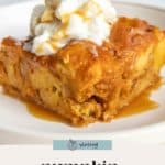 A slice of rich pumpkin bread pudding topped with whipped cream and drizzled with caramel sauce sits on a white plate.