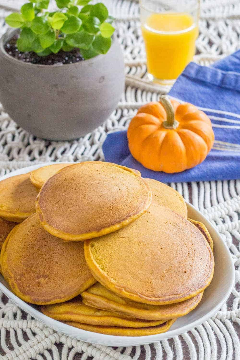 Pumpkin pancakes are the best breakfast for fall! Warming spices and pumpkin make these a great family brunch before hitting the pumpkin patch.