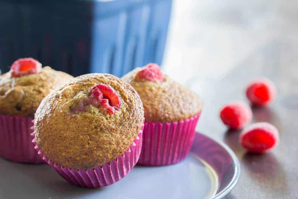 Raspberry bran muffins on a plate.
