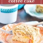 A slice of peach coffee cake with crumb topping sits on a decorative plate, paired with a fork and a steaming cup of coffee.