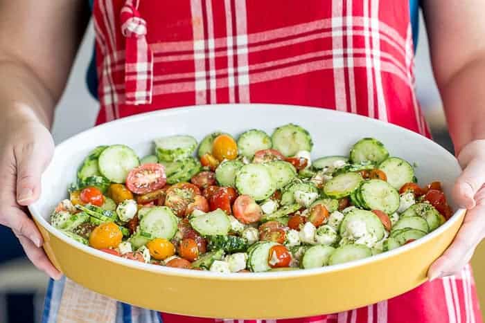 Cucumber tomato salad with pesto brings everything that is great about summer together in one dish. This no-cook dish is ideal for cookouts and potlucks.