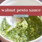 A spoon scoops vibrant green walnut pesto from a white bowl, with text labeling it "walnut pesto sauce.