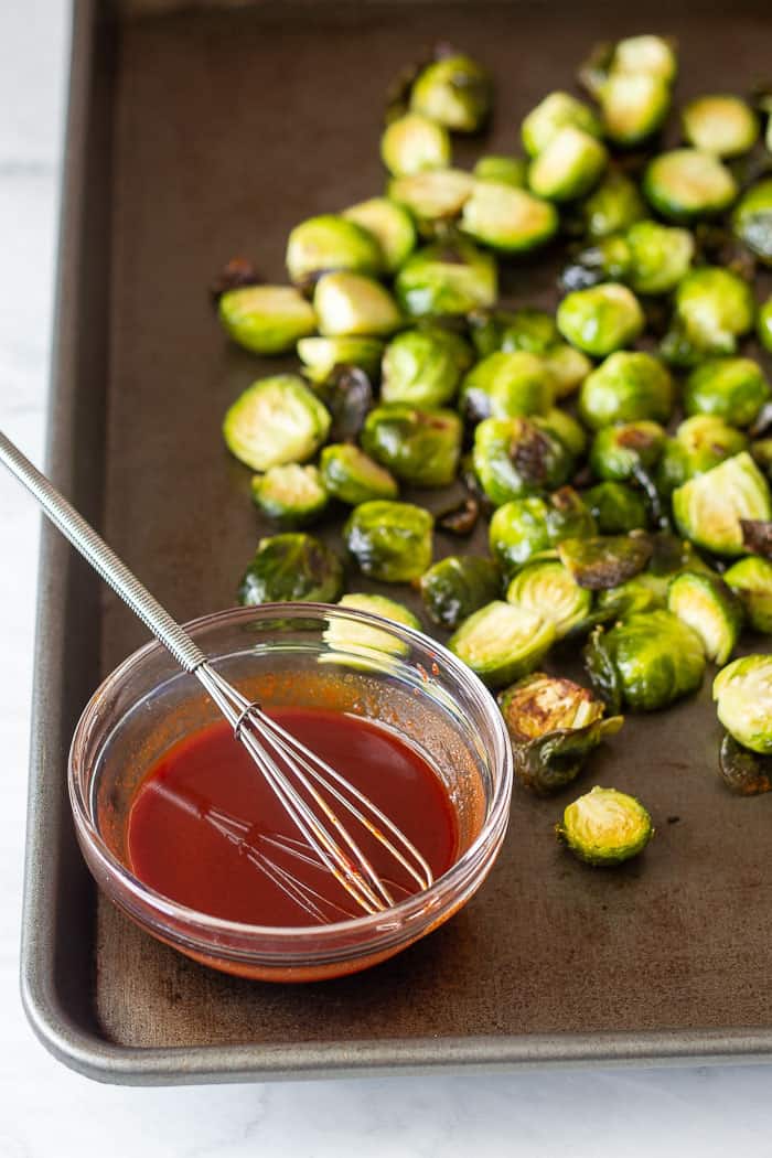 Brussels sprouts on tray with sauce
