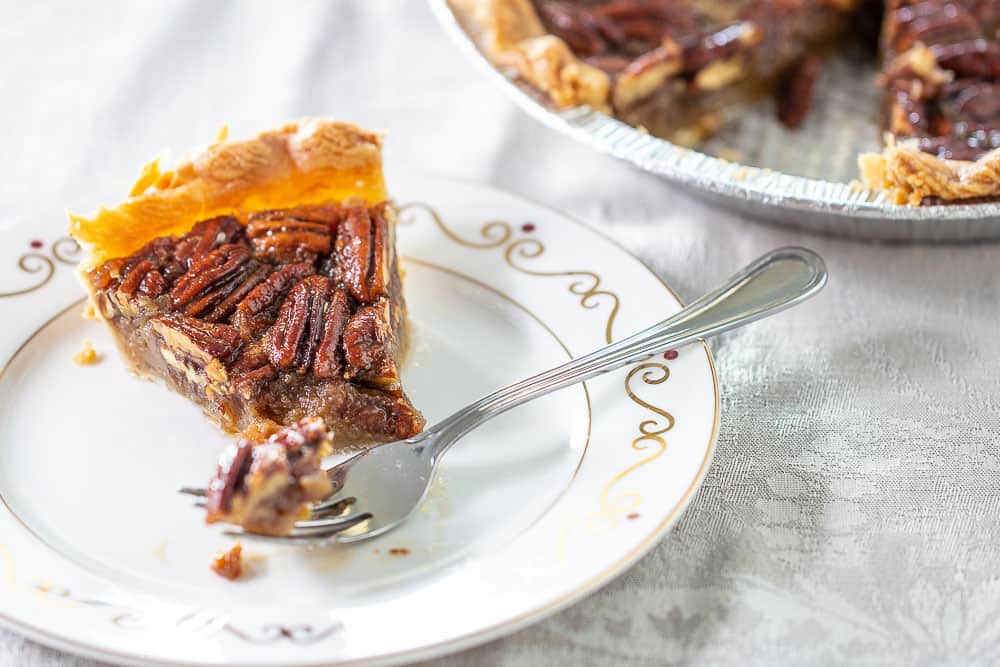 Maple pecan pie with fork and bite