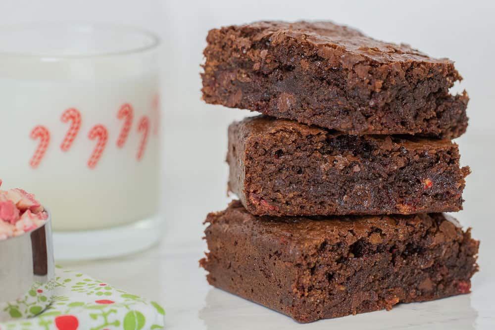 Peppermint brownies cut and stacked with milk