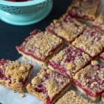 Raspberry pie bars overhead with berries