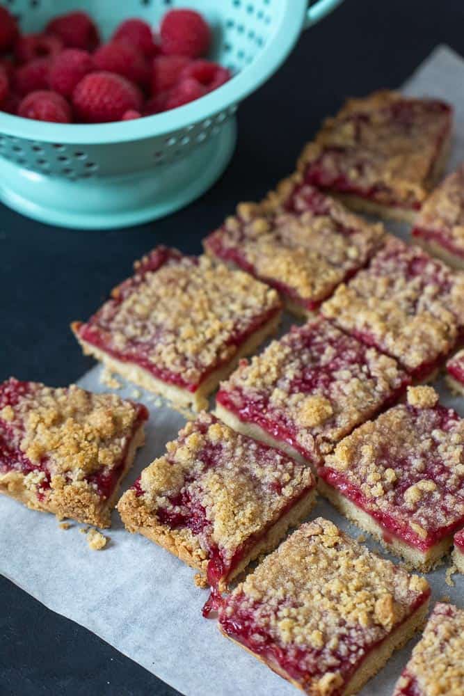 Raspberry pie bars overhead with berries