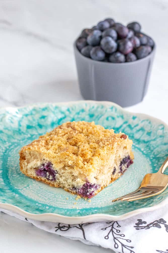 Blueberry coffee cake with blueberries in bowl