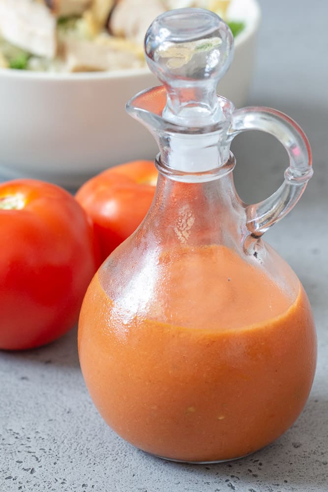 Roasted tomato salad dressing in cruet vertical