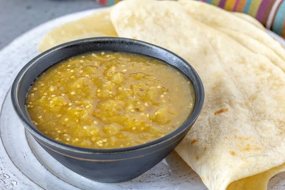 Tomatillo salsa in a black bowl