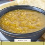 A black bowl filled with vibrant tomatillo salsa sits on a plate with crispy tortilla chips in the background. Text reads "easy tomatillo salsa.
