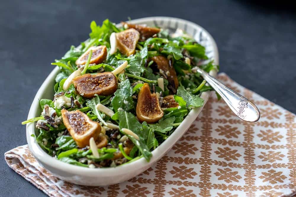 Fig wild rice salad with arugula in a bowl